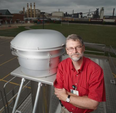 Dr. Jack Harkema, on top of one of the AirCARE mobile air research laboratories.
