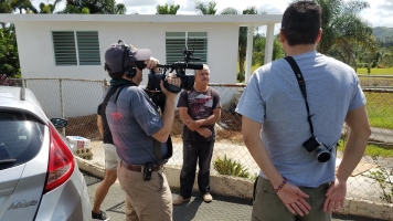 Documenting community impacts in the field. This family lost their entire house and were in the process of rebuilding. Bruno Takahashi is on the right and Bob Gould is filming.