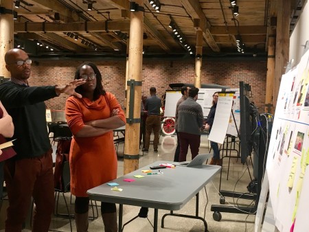 Damon Ross, program officer at the Community Foundation of Greater Flint, and Lottie Ferguson, chief resilience officer for the City of Flint, network at a Flint Leverage Points Project community event.