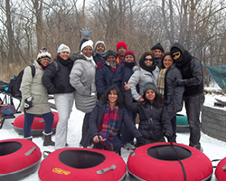 Panamanian public school teachers enjoy Michigan winter tubing.