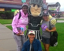 ESL teacher training students from the Panamá Bilingüe Program  pose with Sparty at a baseball game.
