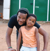 MRULE student with young friend at VVOCF, Zonkizizwe, South Africa