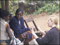 A patient's mother (left) discusses treatment issues with Monica Sapuwa, R.N. (center), of Queen Elizabeth Central Hospital, Blantyre, Malawi, and Gretchen Birbeck (right).