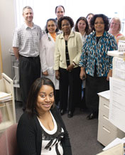 Receptionist Angela Smith, foreground, with staff of Sparrow Health Center. Dr. Lowhim and Dr. Meier are second and third from left.
