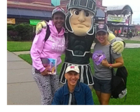 ESL teacher training students from the PanamÃ¡ BilingÃ¼e Program  pose with Sparty at a baseball game.
