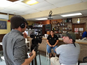 Andy Han and Bob Gould interviewing a restaurant owner in San Juan.
