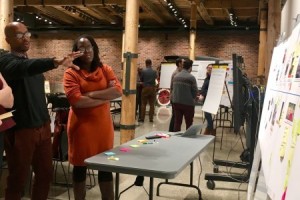Damon Ross, program officer at the Community Foundation of Greater Flint, and Lottie Ferguson, chief resilience officer for the City of Flint, network at a Flint Leverage Points Project community event.