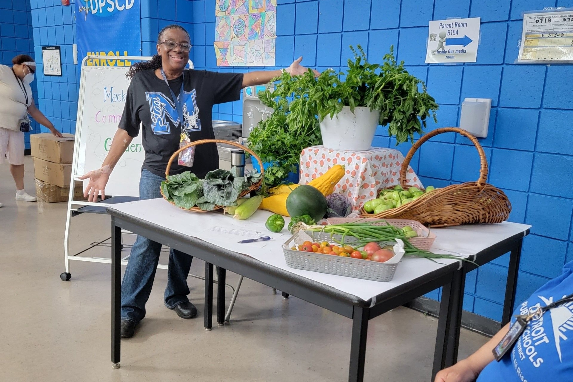 TSO-UP participant Shirley Brezzell, a science teacher at Mackenzie Elementary-Middle School in Detroit, displays a bountiful harvest from the school's rejuvenated vegetable garden.