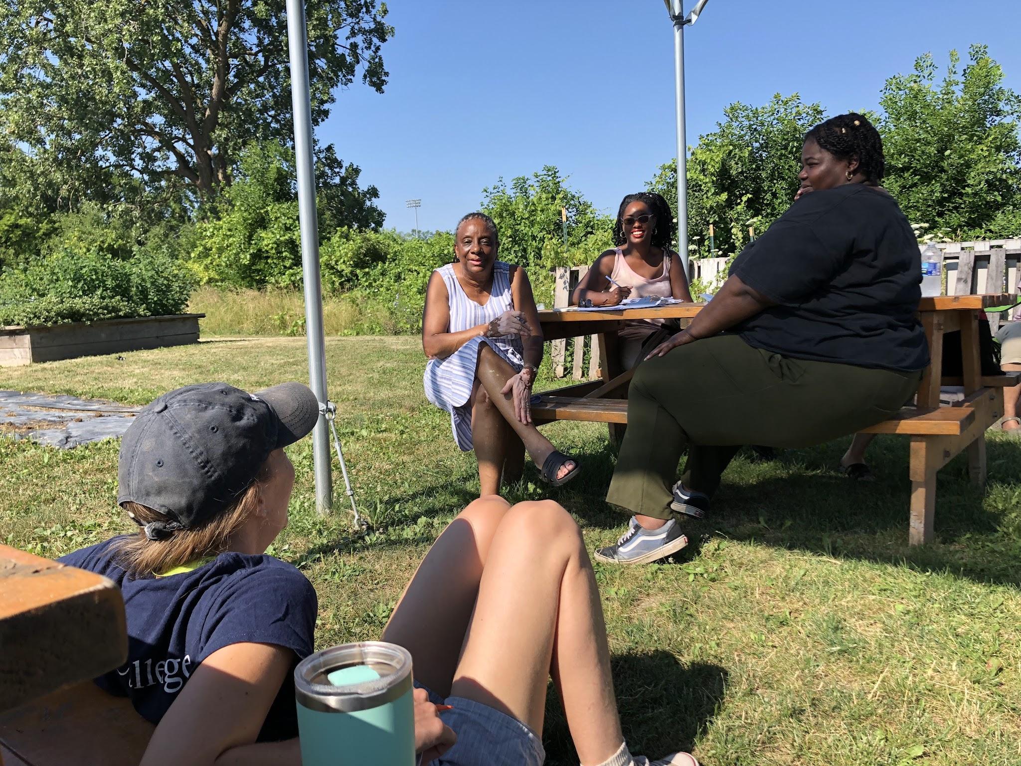 Science teacher Shirley Brezzell (left, at picnic table) shares her experiences with other teachers who participated in a professional learning community as part of Teaching Science Outdoors: Urban Partnerships.
