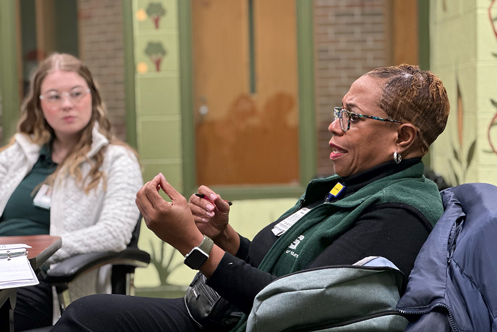Professor Rhonda Conner-Warren talks with students in her community health course before they begin their clinical day at Focus: HOPE in Detroit.