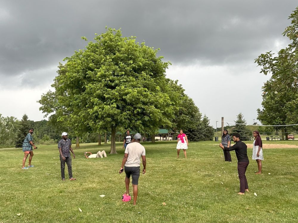 Fellows participated in a pick-up game of soccer during a site visit to Hawk Island Park in Lansing for a traditional potluck picnic and BBQ.