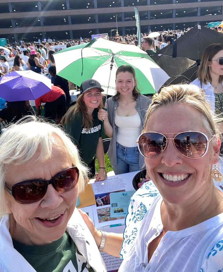 Marcia Van Ness, a member of the East Lansing Seniors Commission, and Melissa Fore braved an 89-degree day to promote Generations Connect at Sparticipation 2024. In the background are MSU students Emily Mason and Eleanor Pugh. Van Ness serves as a liaison to Generations Connect, promoting the program and offering a senior perspective.