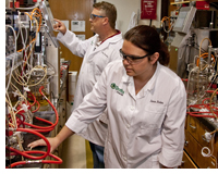MSU Graduates and Draths employees Sara Boles and Craig Banotai check processes in the Okemos laboratory.