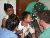Peter LaPine and medical students assist a young patient at the Angel Notion Clinic.