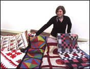 Mary Worral, Quilt Project manager and assistant curator, MSU Museum, displays quilts from the collection