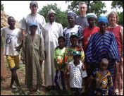Sam Worland-Esquith, Stephen Esquith, and Chris Worland (back row) pose with Sam's host family in Diokeli, Mali, where Sam was a Peace Corps volunteer in 2001.