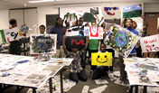 Young students in a My Brother's Keeper workshop show their art created with Emmanuel Nkuranga (left), a visiting artist from Rwanda.