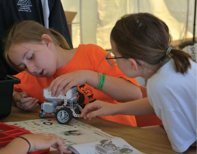 Youth compete in a 4-H regional robotics competition, in which they design and build a robot that must complete a prescribed task.