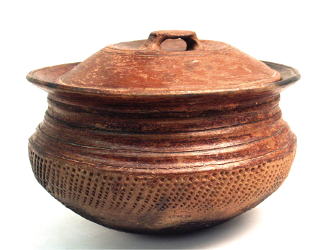 During her field work, Achebe has received many gifts, including Igbo pottery similar to this clay pot. Pottery is one of the oldest of Igbo cultural traditions, primarily performed and maintained by women.