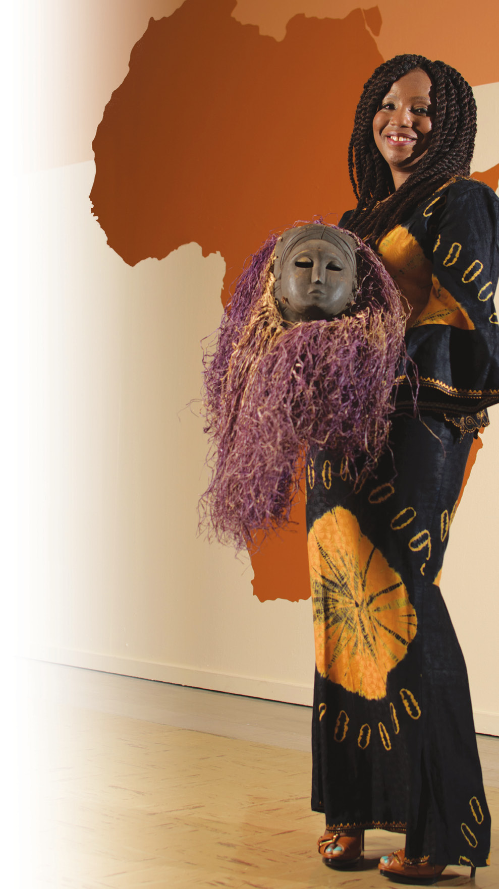 Nwando Achebe holds a mask used in religious practices in Nigeria. The spirit of a deceased loved one visits via the mask during a ceremonial performance.