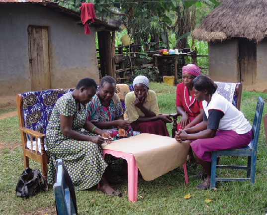 Women draw garden tools in rural Kenya.
