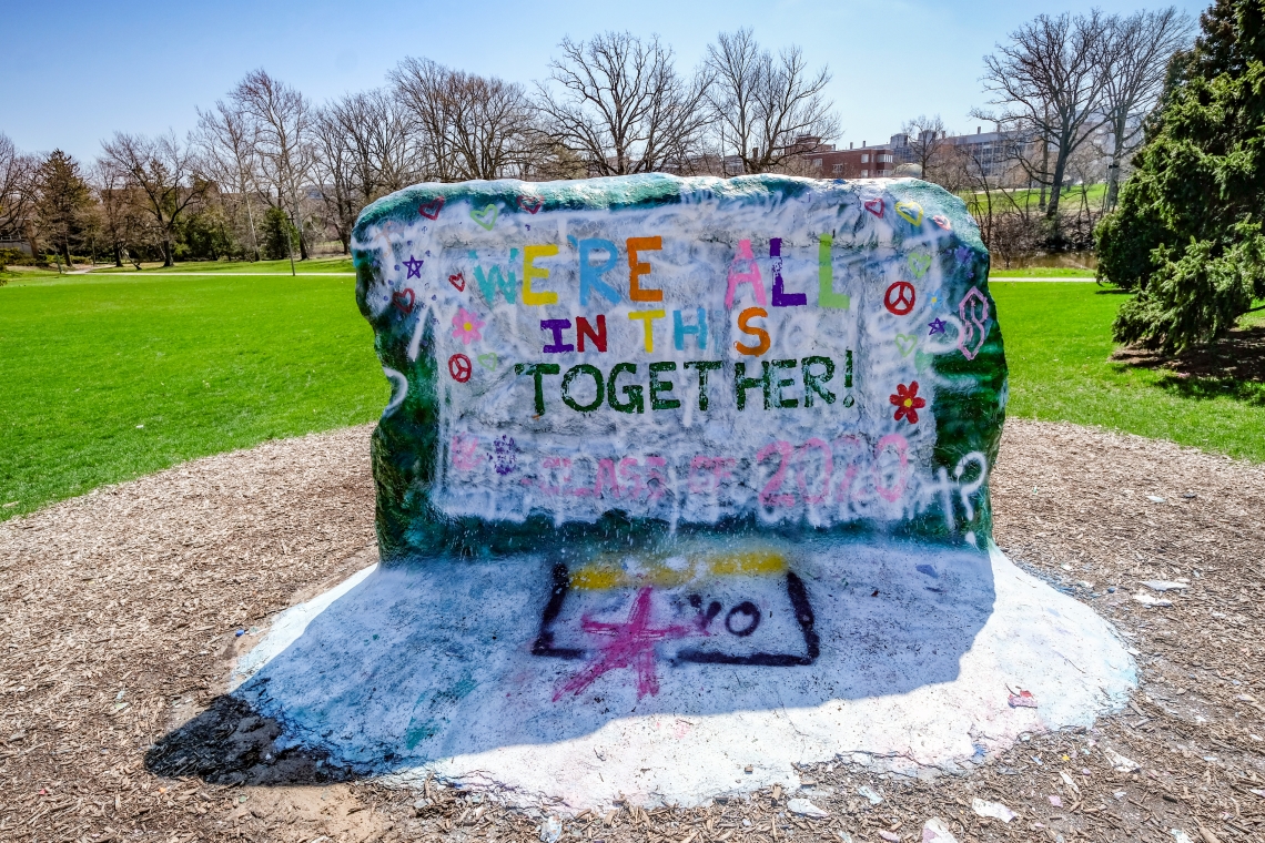 Students paint the rock on campus with messages of unity.