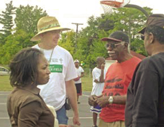 Jonathan Morgan (in straw hat) chats with neighborhood residents at a Fletcher Field event.